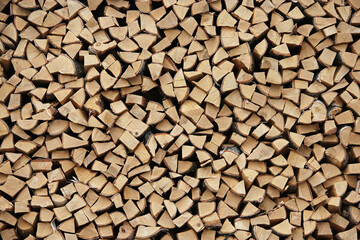 Wooden background or texture for your interior design. Chopped birch firewood