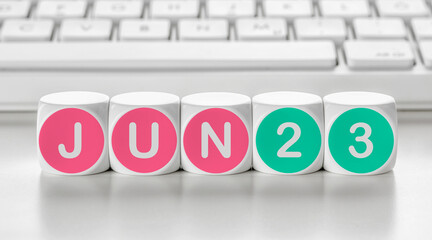 Letter dice in front of a keyboard - June 23