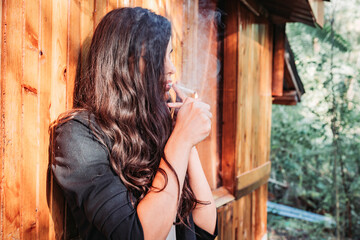 Portrait of a beautiful brunette girl smoking