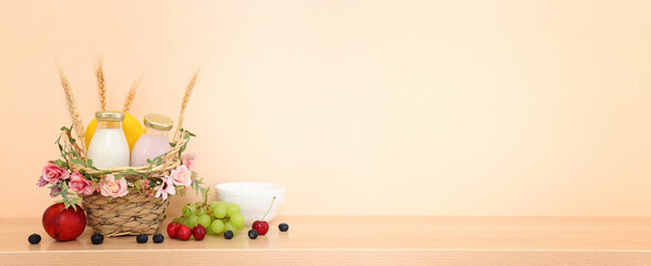 Photo of dairy products over wooden table. Symbols of jewish holiday - Shavuot