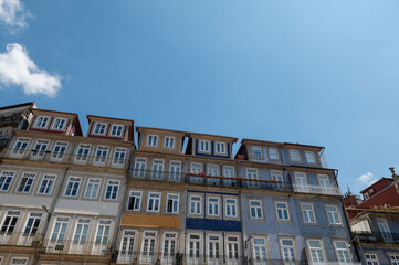 Fototapeta na wymiar Facades of houses with tiles in the city of Porto in the summer of 2022.