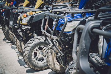 Fototapeta na wymiar View of row dirty ATVs quad bike