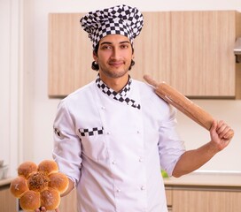 Young male baker working in kitchen