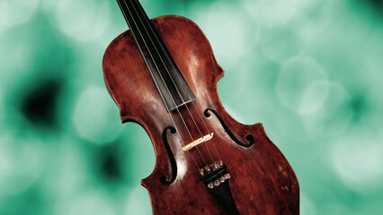 Body of violin on green blurred background