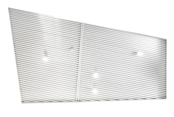 Ceiling with bright lights in a modern warehouse, shopping center building, office or other commercial real estate object. Directional LED lights on rails under the ceiling