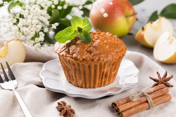 Apple muffin on a plate, decorated with fresh mint