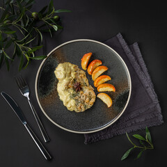 Cod fillet with spices and apples. View from above. Black background.