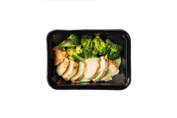 Healthy meal, container with chicken breast and broccoli. A set of food for keto diet in a plastic container isolated on white. Top view