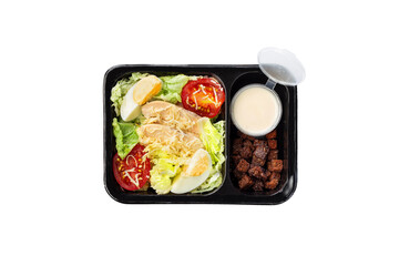 Healthy meal, container with chicken salad. A set of food for keto diet in a plastic container isolated on white. Top view