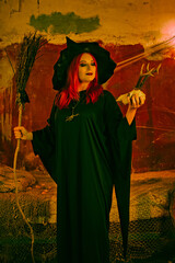 Witch in a red-haired hat. Halloween concept.