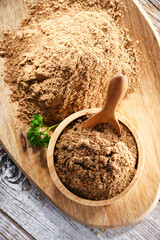 Composition with a bowl of ground coriander