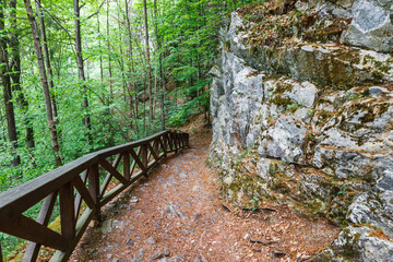Walking trail in the mountains with wooden handrails