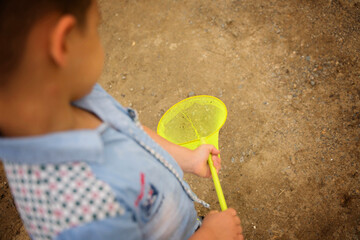 little boy holding a yellow net