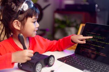 Asia students learn at home in coding robot cars and electronic board cables in STEM, STEAM, mathematics engineering science technology computer code in robotics for kids concept.
