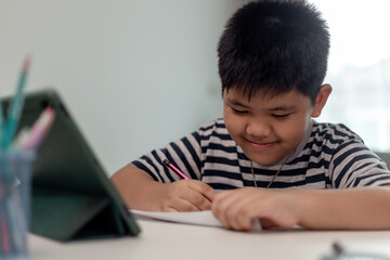 Kid self isolation using tablet for his homework,Child doing using digital tablet searching information on internet during covid 19 lock down,Home schooling,Social Distance,E-learning online education