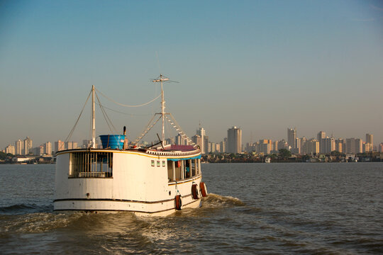 Riverside view of the skyline of Bel&eacute;m do Par&aacute;, metropolis of the Brazilian Amazon, with small ferry boat on the foreground. January, 2008.