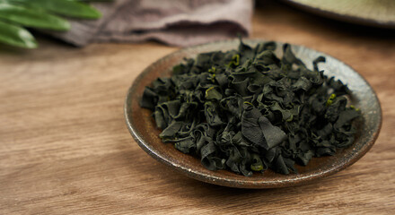 dried Laminaria (Kelp) Seaweed on ceramic bowl Background. dried Laminaria or kelp Seaweed on bowl Background. konbu, alga, wakame