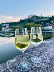 glass of white wine on the old main Bridge with Festung Marienberg Würzburg