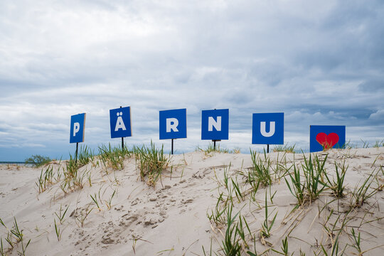 Pärnu sign on sand dunes at Pärnu beach. Viewpoint with Pärnu sign.