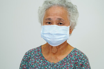 Asian elderly woman patient wearing a mask for protect Covid-19 Coronavirus.