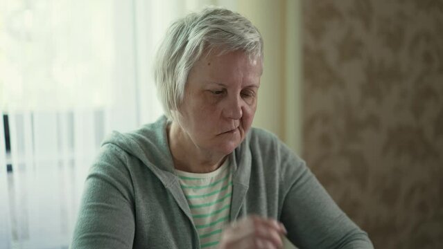Old woman with face paralysis take a medicine