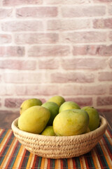 Close up of fresh apple in a bowl on wooden table 