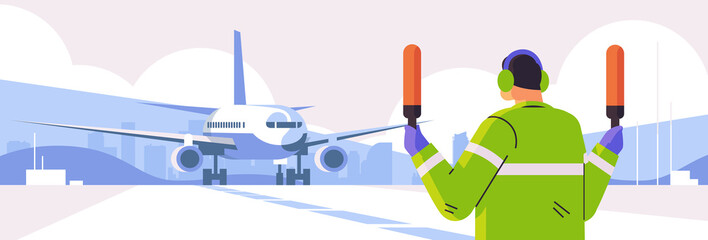 aviation marshaller signaling near aircraft air traffic controller airline worker in signal vest professional airport staff © mast3r