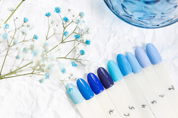 Different blue nails polish manicure palette Background. 