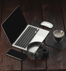 Workspace mockup template  on wood structural background. Musician composer workplace with headphones, laptop, phone and cup of coffee
