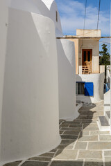 Fototapeta na wymiar A street in the old town of Chora, the capital of Ios Island. Traditional Cycladic architecture. Greece