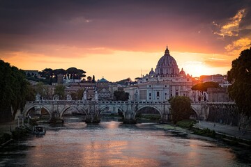 Obraz na płótnie Canvas Sunset view of old Sant' Angelo Bridge and St. Peter's cathedral in Vatican City, Rome.Italy