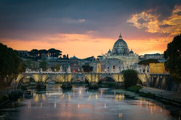 Fototapeta na wymiar Sunset view of old Sant' Angelo Bridge and St. Peter's cathedral in Vatican City, Rome.Italy