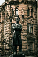 Fototapeta premium Monument to Pushkin, a pigeon sitting on its head, photo on the street