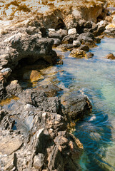 Detail of a rocky coastline on the island of Naxos in Greece