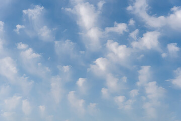 Background of white clouds in a blue sky, clouds leaving traces by the action of the wind.