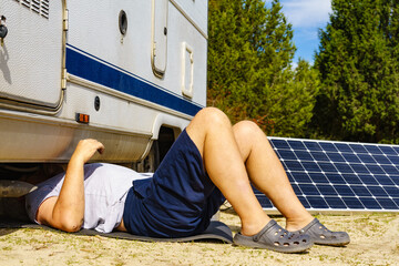 Man repairing bottom of the rv caravan