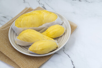 Fresh durian in packaging on plate Durian king of Thailand fruit. Famous tropical fruit. Shot from top view.
