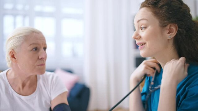 Physician satisfied with senior patient's health check-up, writing down results
