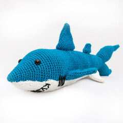 crocheted blue shark isolated on white