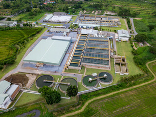 Aerial view of circular water treatment tank for cleaning up and recycling the contaminated wastewater from industrial estate - obrazy, fototapety, plakaty
