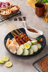 Sate Kacang or Chicken satay is Indonesian traditional Food skewered with grilled meat and rice cake , served with peanut sauce