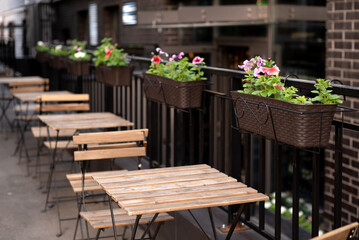 Fototapeta na wymiar row of free tables in street outdoor cafe