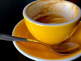 Drunk morning coffee in empty yellow cup. Foam from coffee on the edges of empty dirty cup