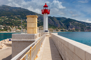 Menton. Stone lighthouse on the breakwater at the entrance to the port.