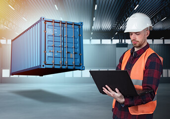 Man with laptop in storage hangar. Blue cargo container. Sea container for transportation goods....