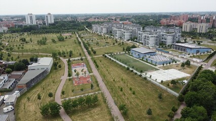 Obraz premium Drone view of Sei Milano, new GARDEN CITY in the western suburbs near Bisceglie subway. Urban regeneration project and green revolution - the park near the new skyscrapers site 