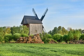 Fototapeta na wymiar wooden old windmill, beautiful rural landscape