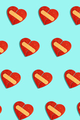 Broken red heart with medical patch on blue background. Abstract pattern love concept