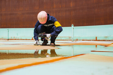 Fototapeta premium Male worker are for inspection ultrasonic thickness roof plate top