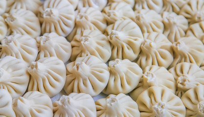 Raw khinkali on the kitchen table. Selective focus.